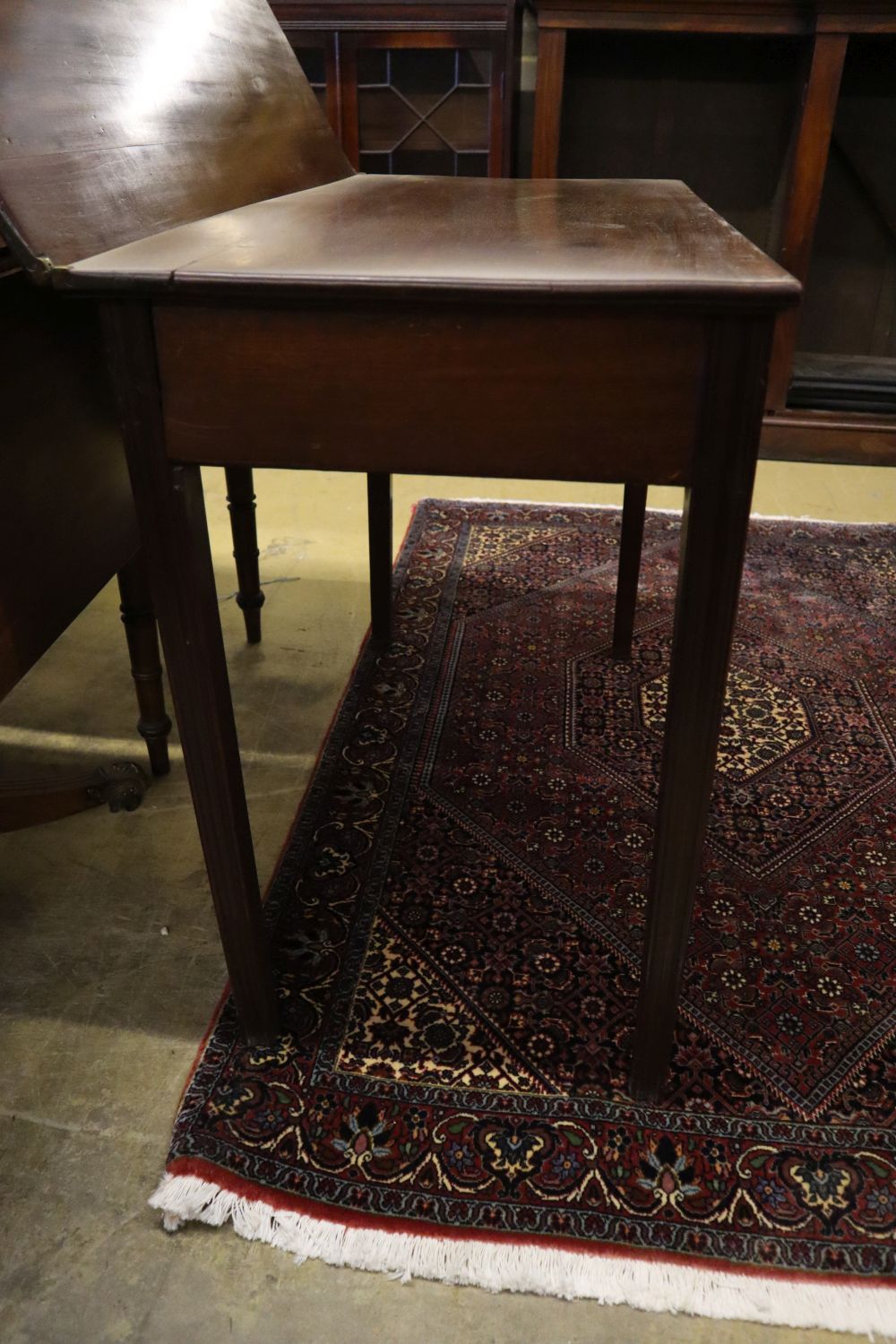 A George III rectangular mahogany folding tea table, width 91cm, depth 44cm, height 72cm